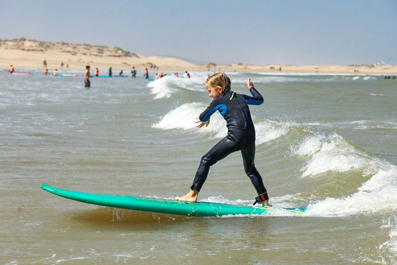 A child surfs on the beach in Essaouira - a popular destination for an 8 days itinerary of the Atlantic Coast