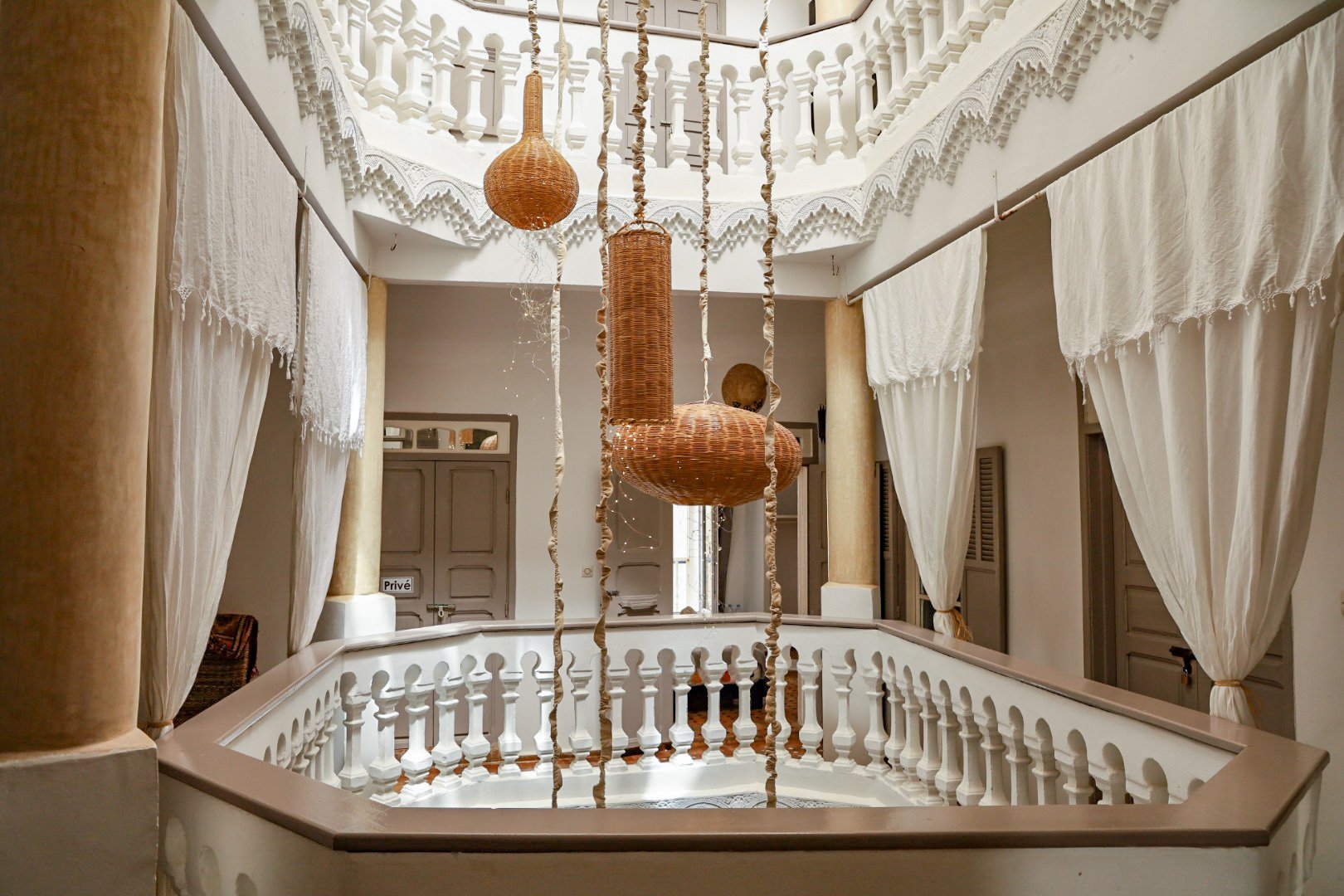 A beautiful riad in Essaouira, Morocco. Lanterns hang through the boutique floors of Lyon Mogador riad.